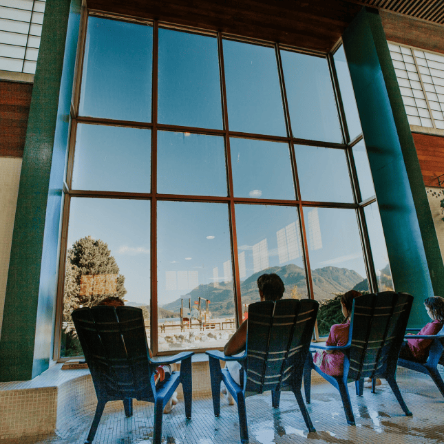 People sitting on chairs at the Harrison Hot Springs Public Mineral Pool