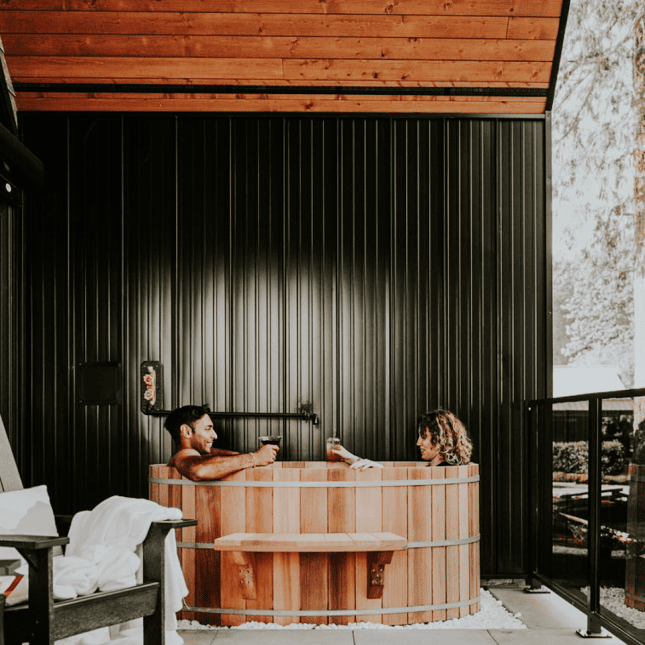 Two people in a wooden hot tub