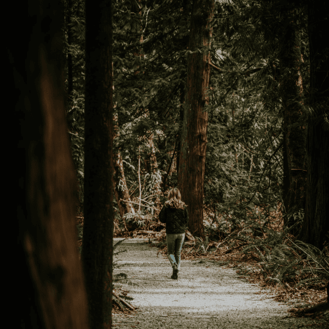 Woman walking through a trail