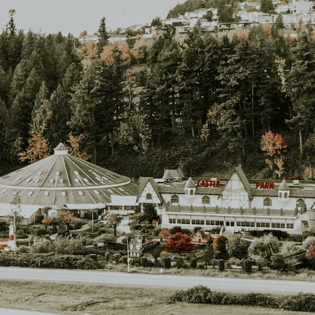 Outdoor view of Castle Fun Park with mini-golf course surrounded by trees and mountains.
