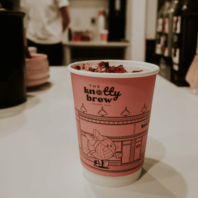 Takeaway coffee cup on a café counter.