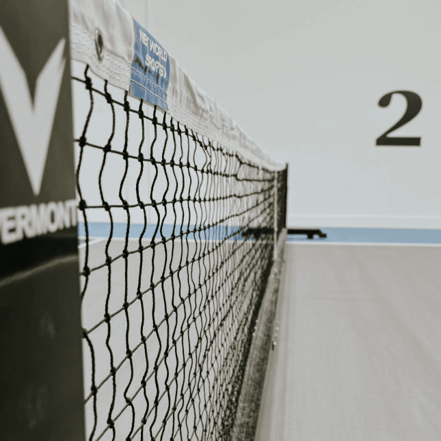 Close-up of a net on an indoor sports court.