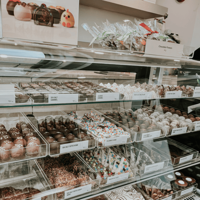 Display case filled with assorted pastries inside a bakery.