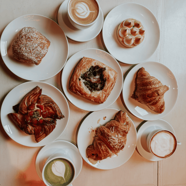 Overhead view of plated small dishes and desserts on a table