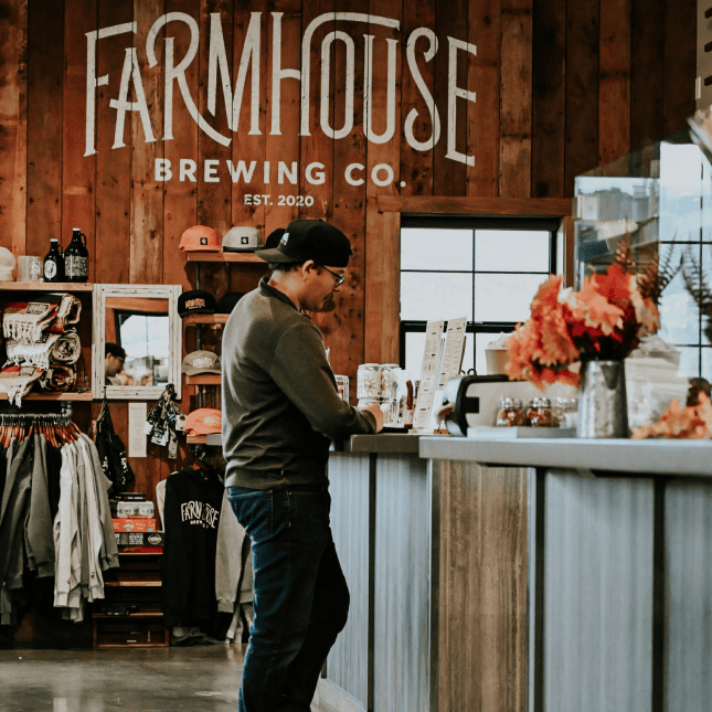 Person ordering at a brewery counter.