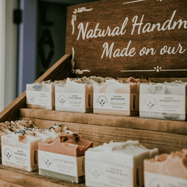 Display of handmade soaps labeled “Natural Handmade.”