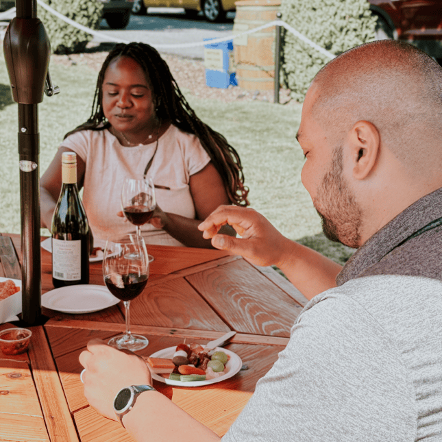 Two people seated at a table enjoying a wine tasting.