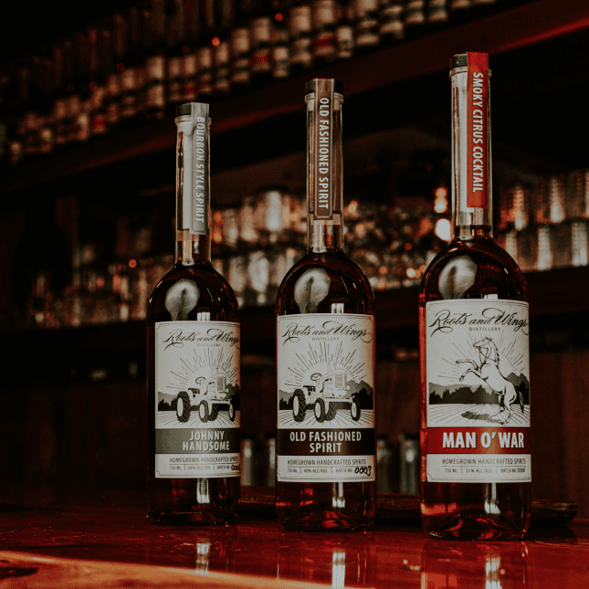 Bottles of liquor displayed on a backlit bar shelf.